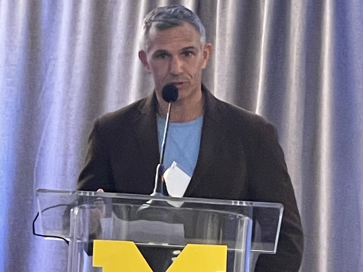 Dave speaking at a University of Michigan podium