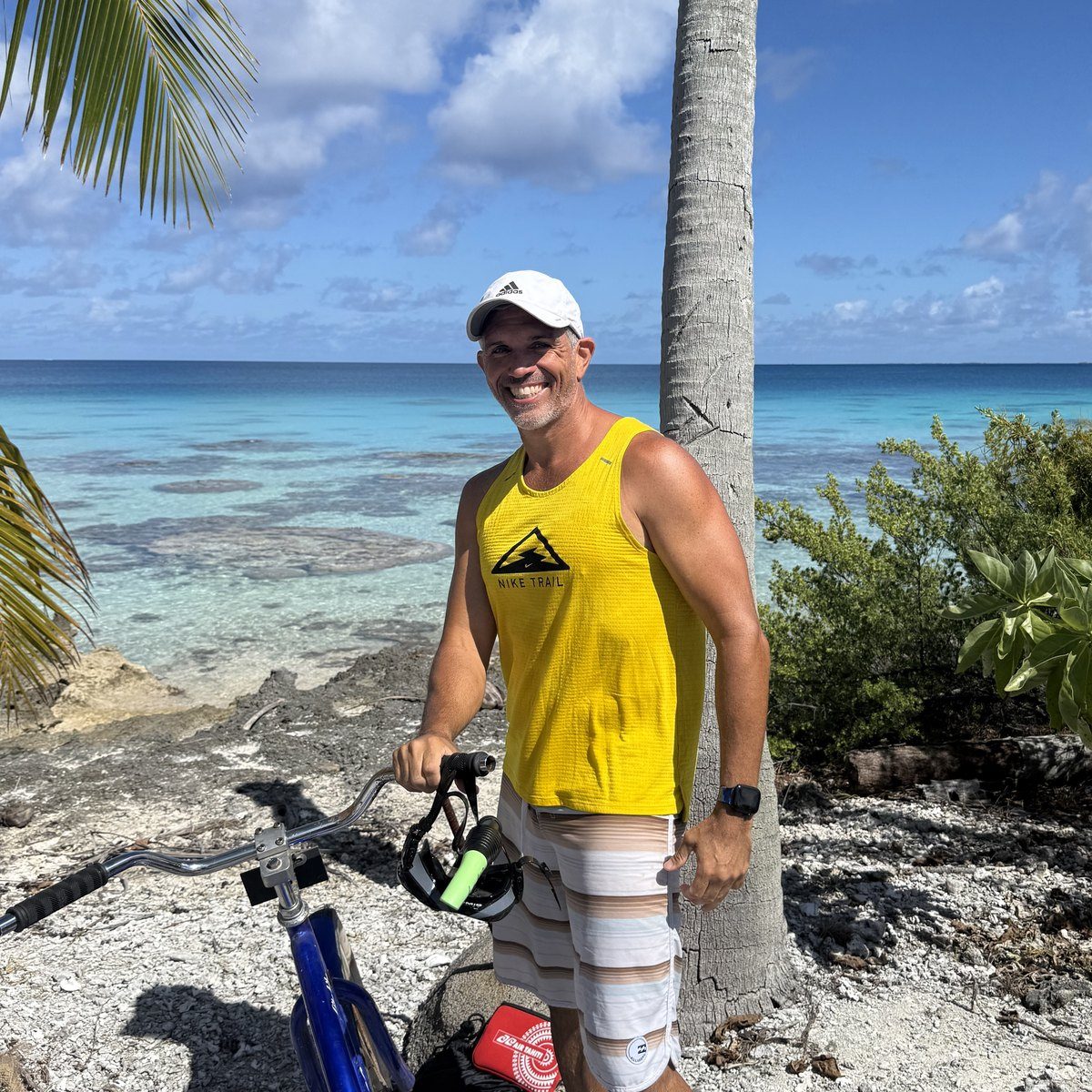 Dave with a bike on a coral beach on a diving trip